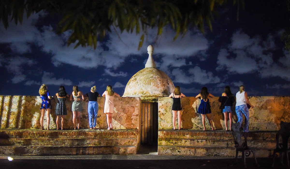Students standing in front of a fountain in Puerto Rico