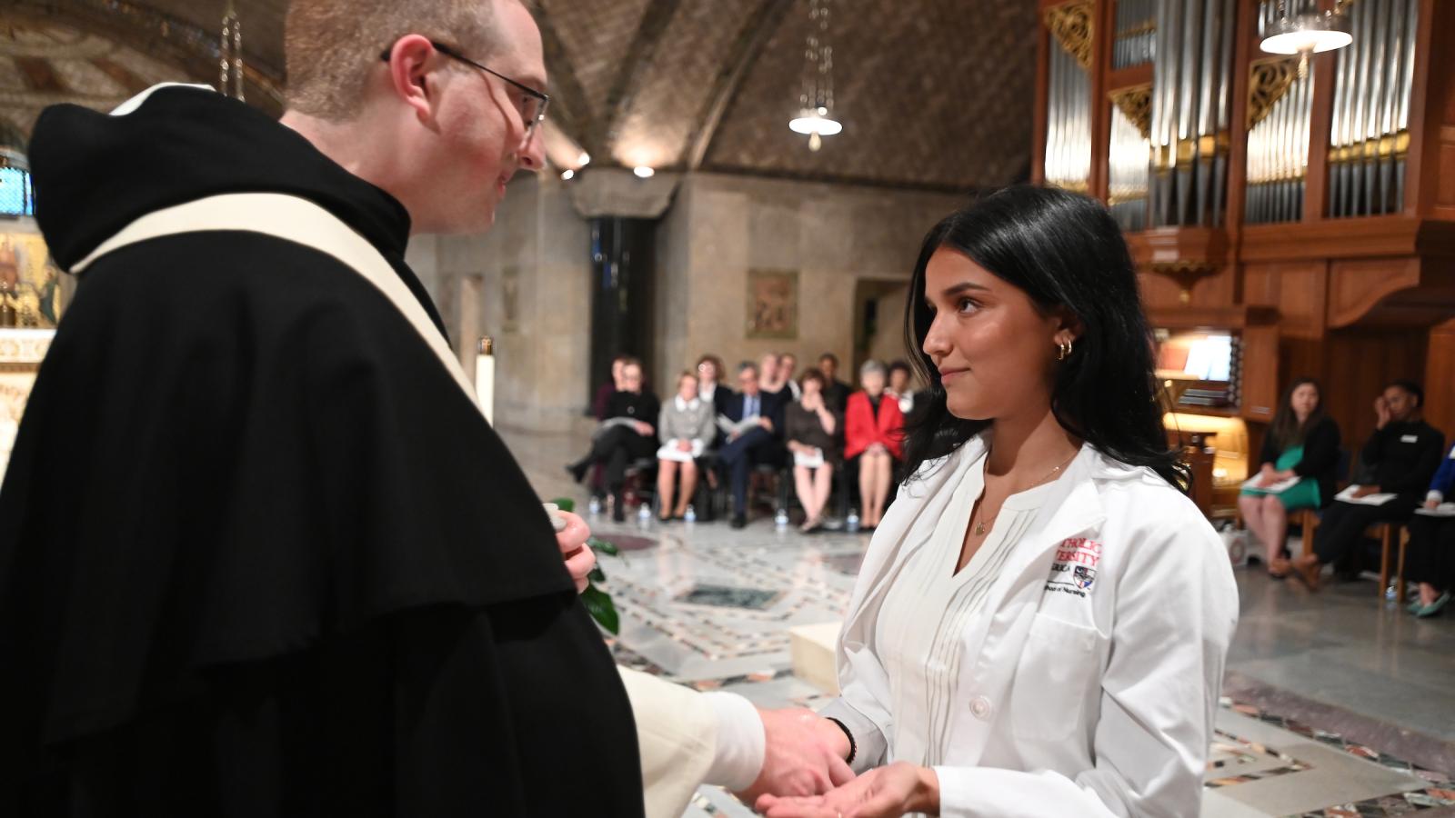 In a moving ceremony reflecting the higher purpose of healthcare, 84 junior nursing students at Catholic University’s Conway School of Nursing received the traditional Blessing of Hands on Oct. 18.The annual ceremony acknowledges the sacred nature of the nursing profession and reflects the University's commitment to cultivating healthcare professionals who provide compassionate, holistic care in the spirit of Jesus Christ's healing ministry. 