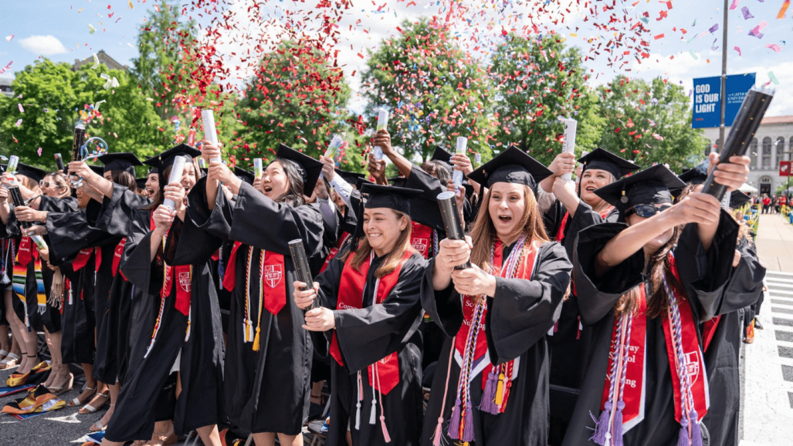 Conway School of Nursing students at their Commencement, popping confetti canons in celebration.