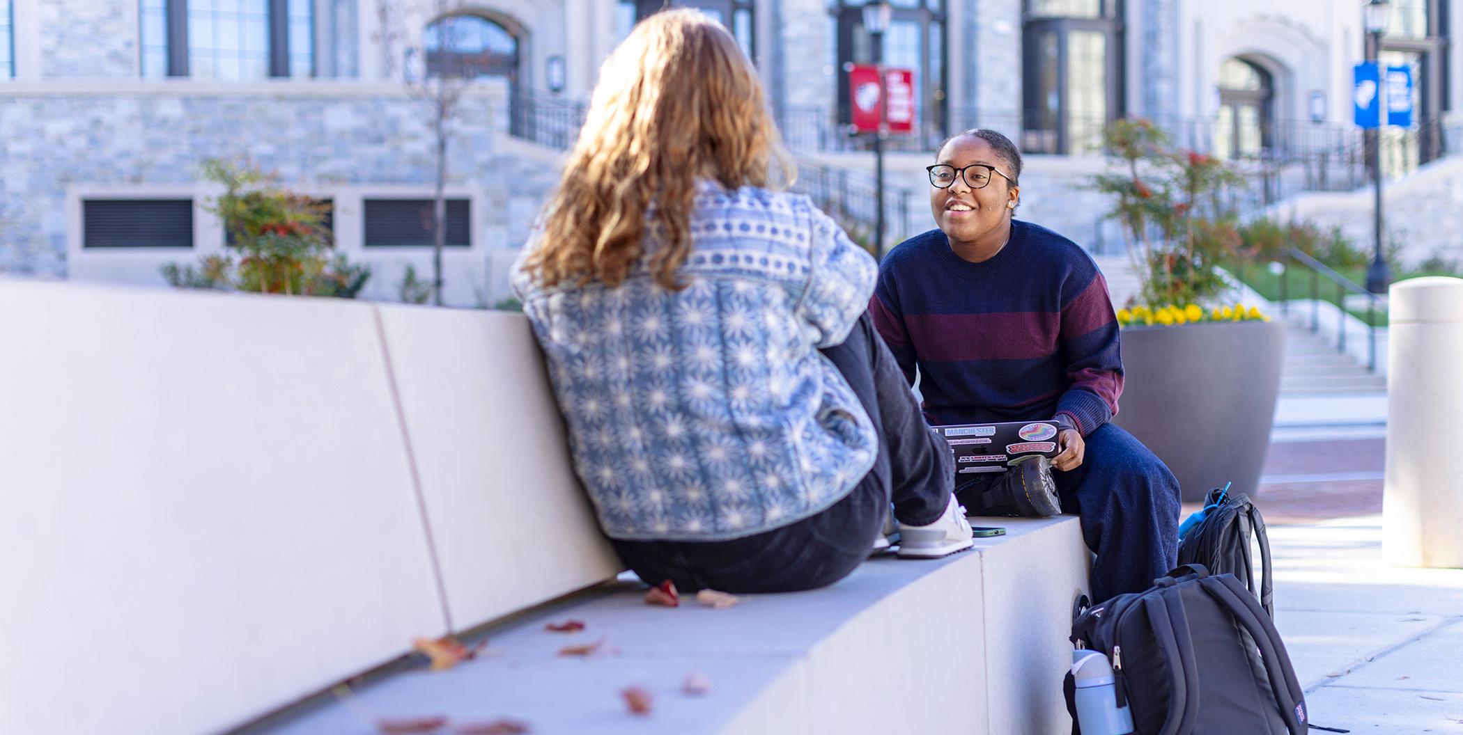 Students talking outside Conway Building.