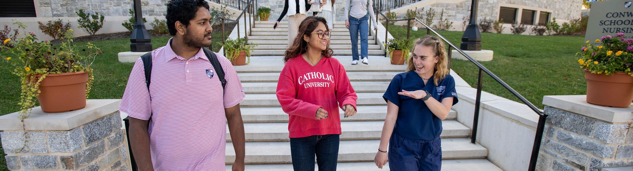 Students walking down steps in front of Conway.