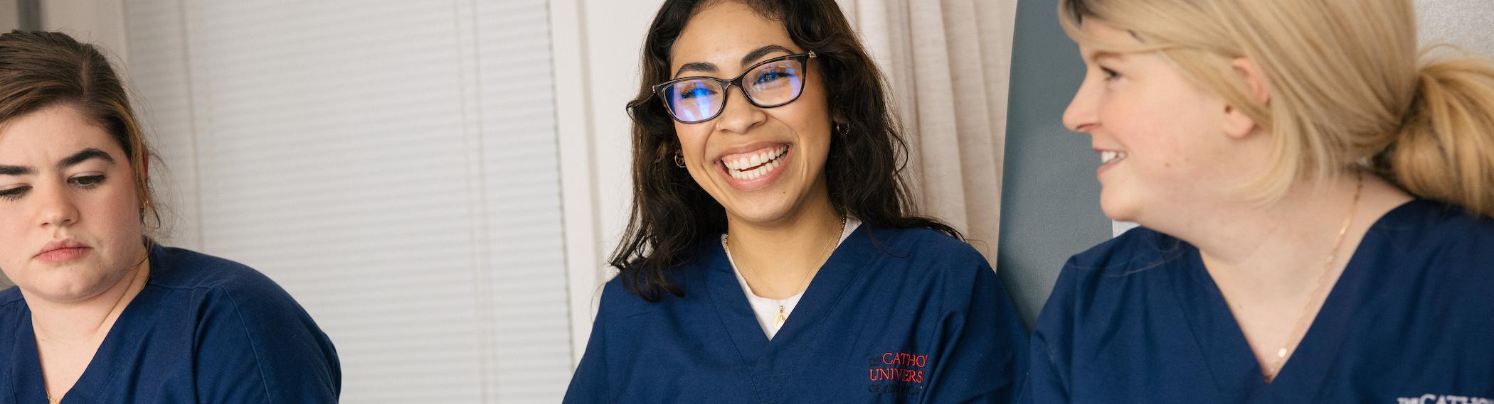 students smiling in their scrubs