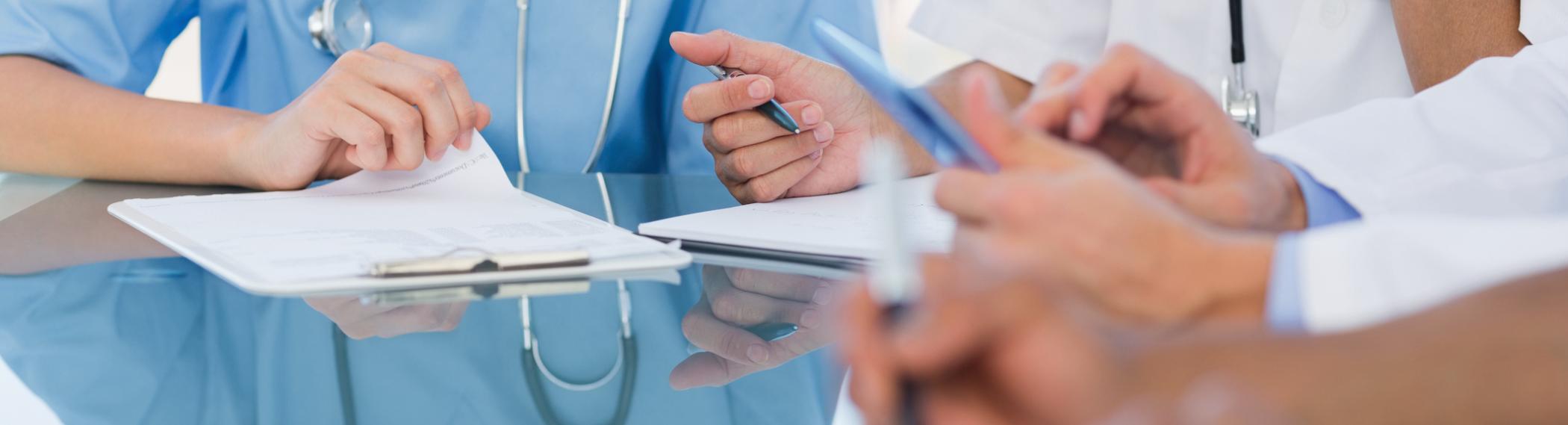 table of nurses and doctors hands