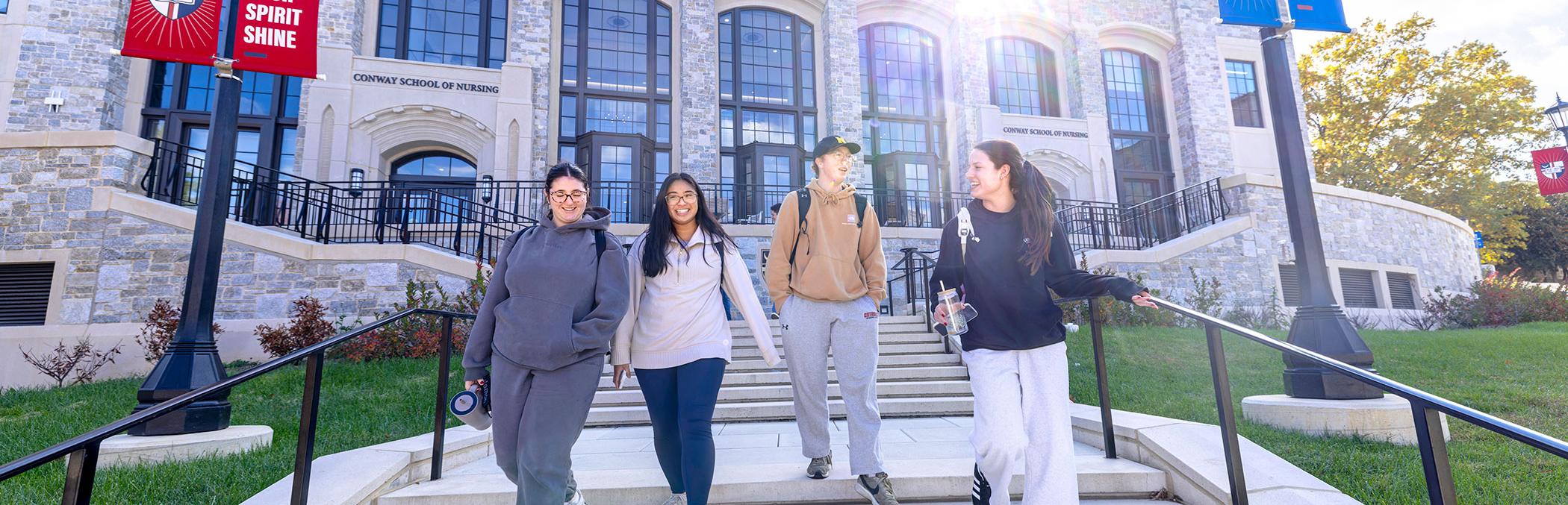 Students walk in front of the Conway Building.