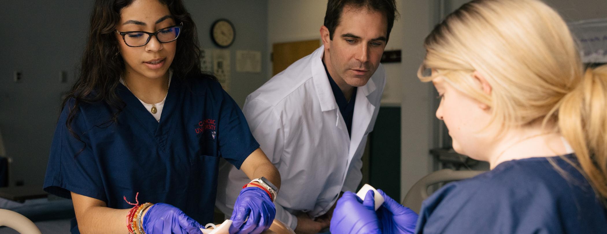 nursing students working on a patient