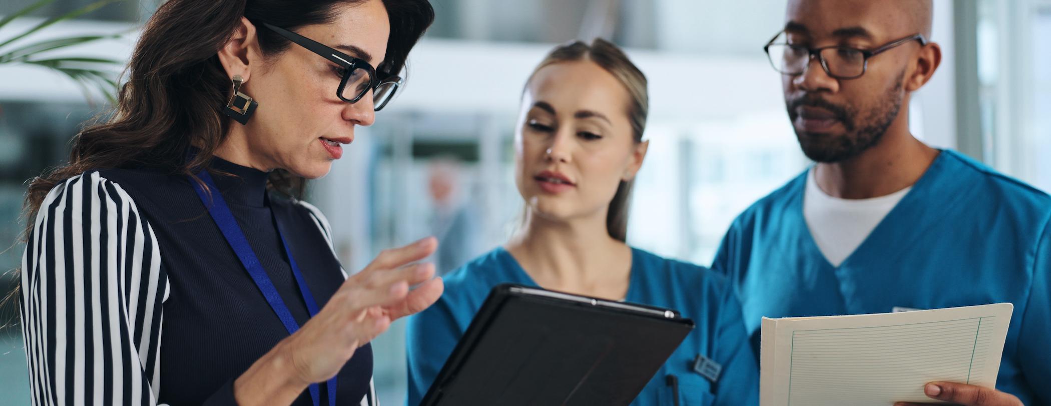 hospital exec talking to a male and female nurse