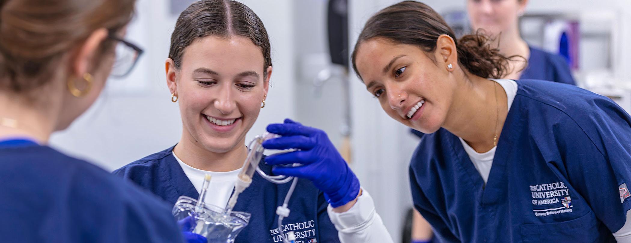 Nursing students with IV bag.