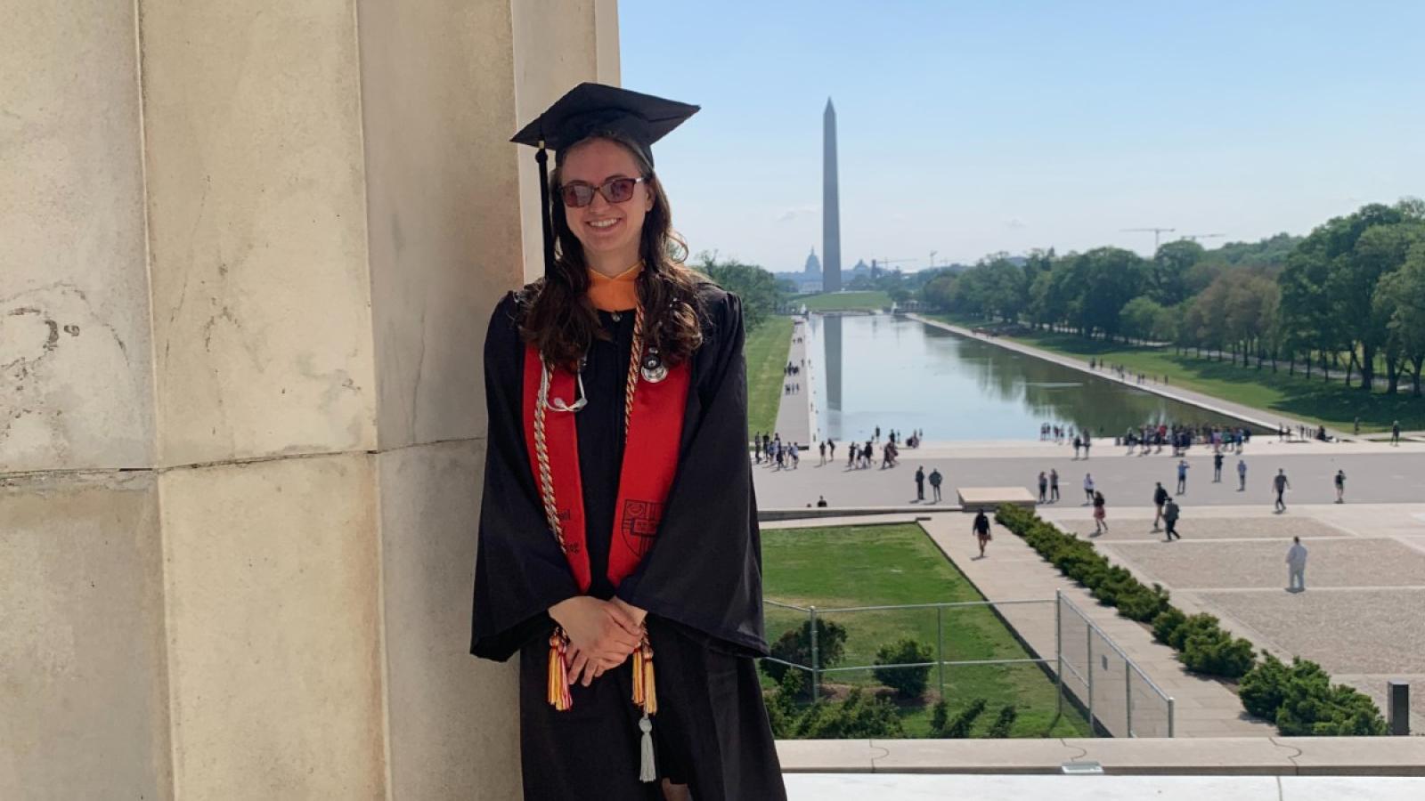 amanda in her cap and gown with the washington monument in the background