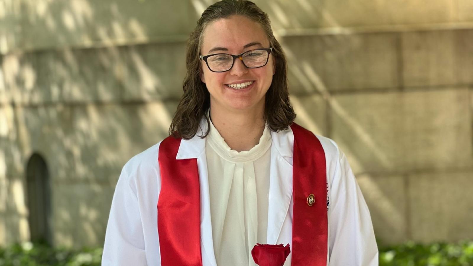 amanda in her white nursing gown and red stole