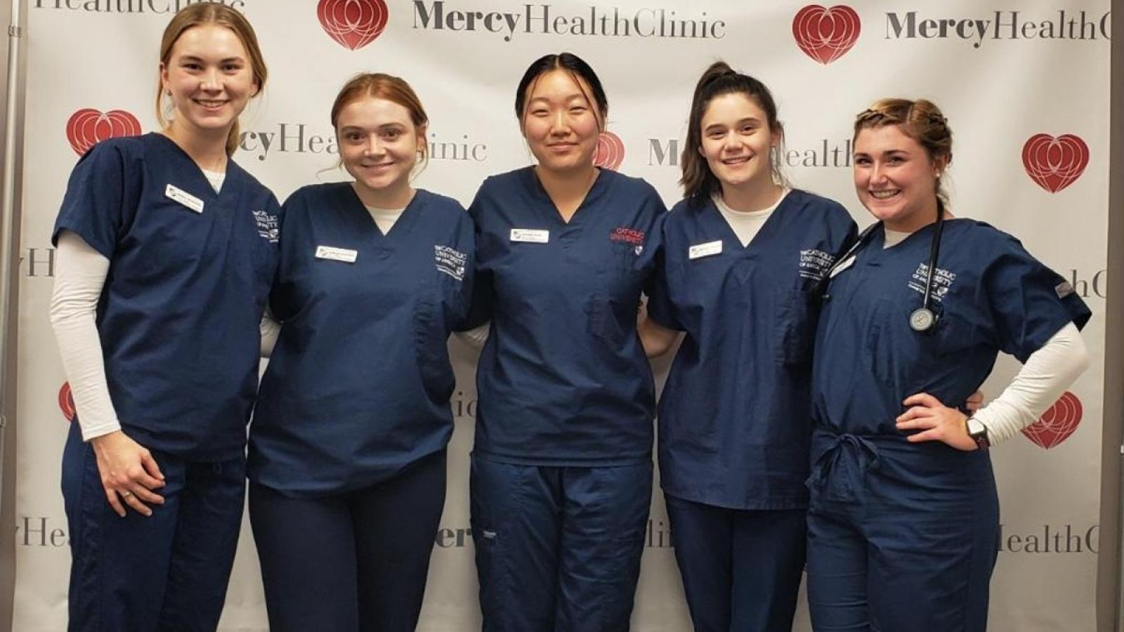 kaelyn and friends in their nursing scrubs