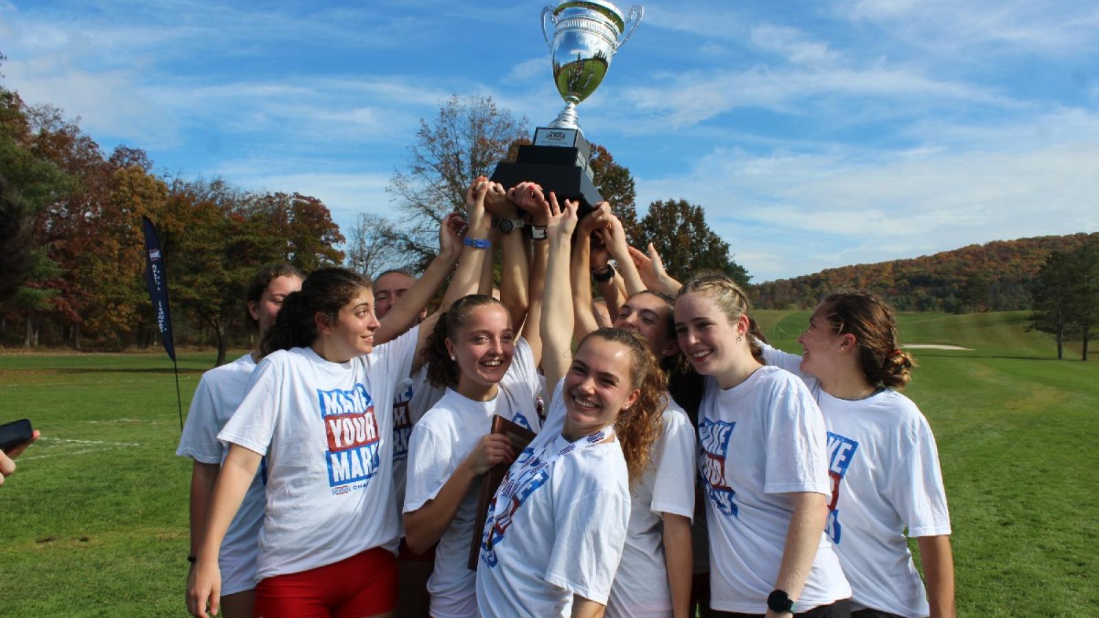 sarah and her team celebrating with a trophy