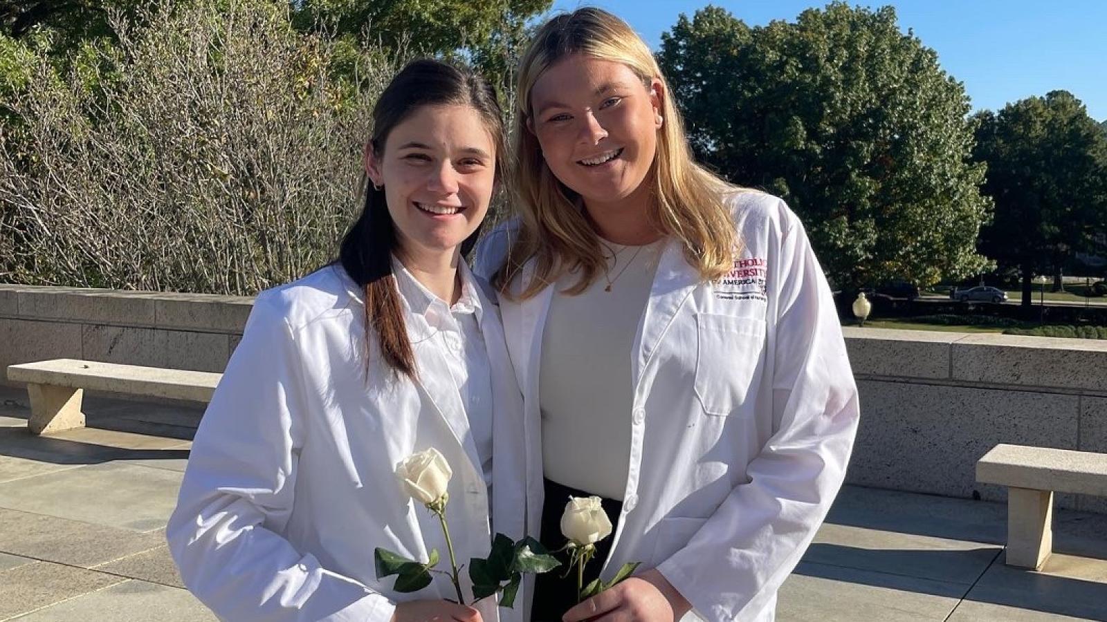 whitney and a friend in their white nursing lab coats