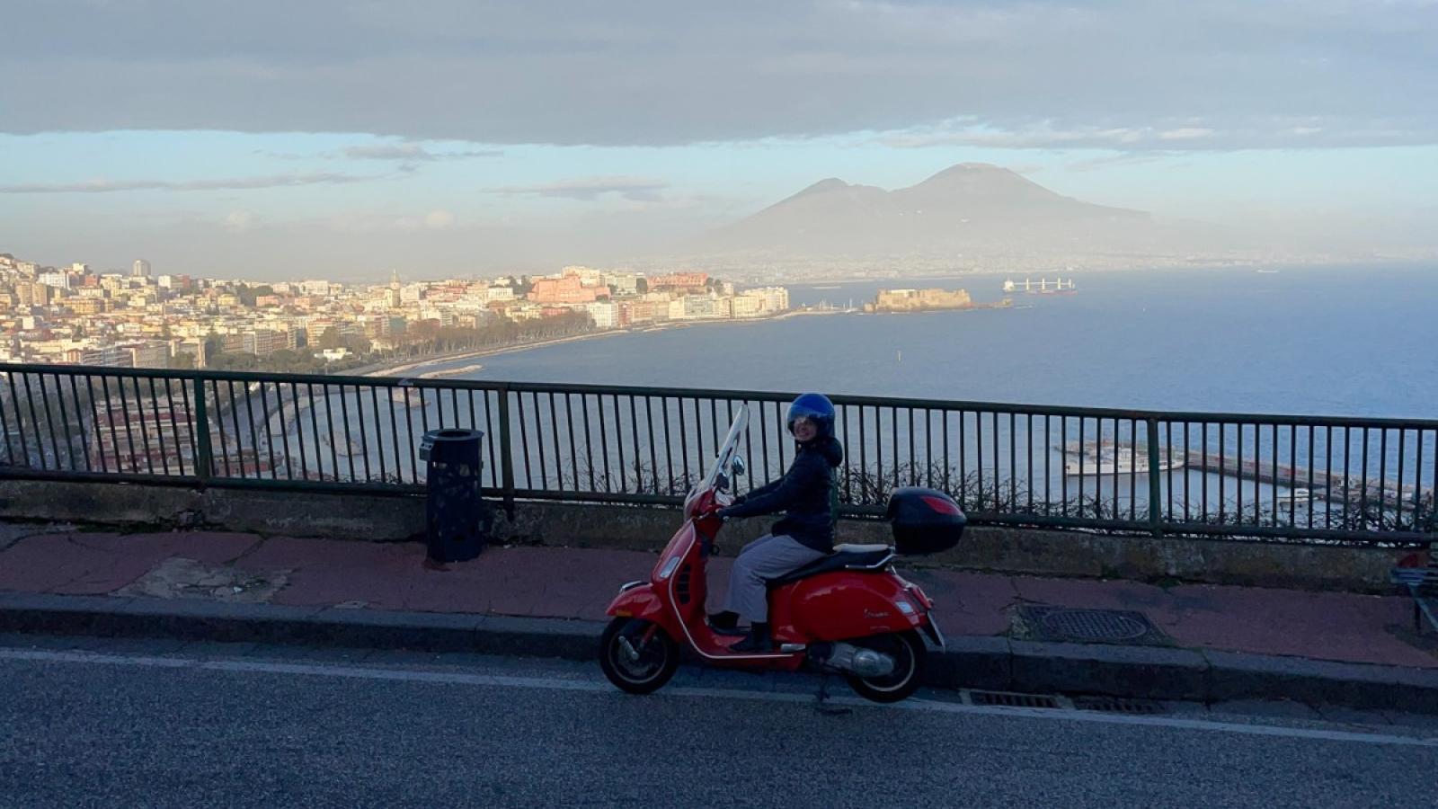 amelia riding a vespa in naples