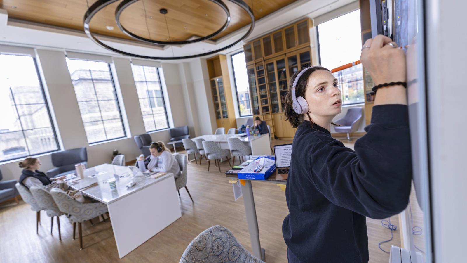 students studying in a spacious library-study looking room in the nursing school