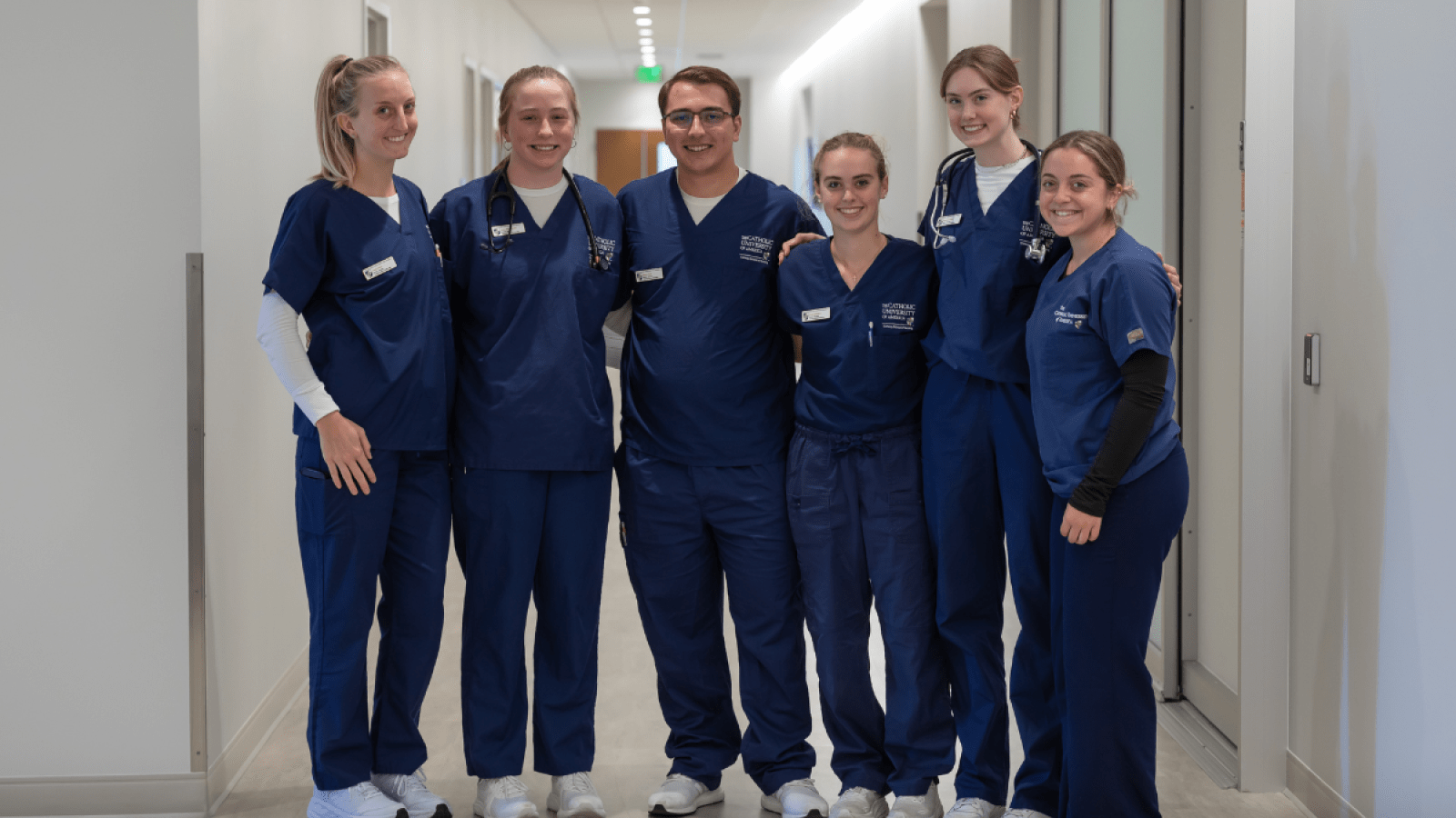 Conway School of Nursing students in blue scrubs.