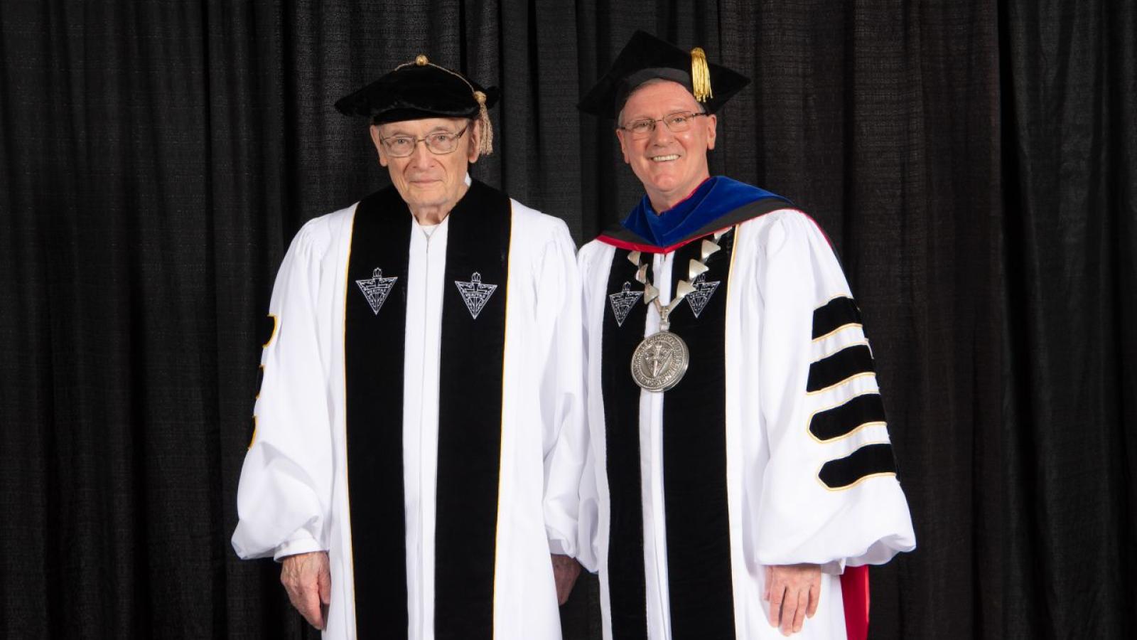 Brother Ignatius being recognized as a Living Legend. He is posing for a photo.