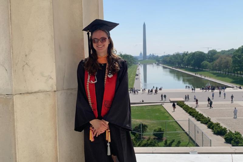 amanda in her cap and gown with the washington monument in the background