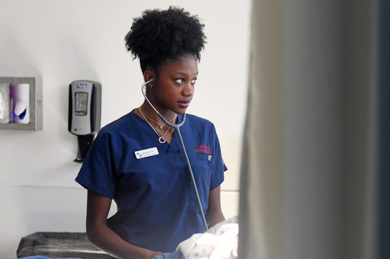 a conway student in her scrubs and stethescope