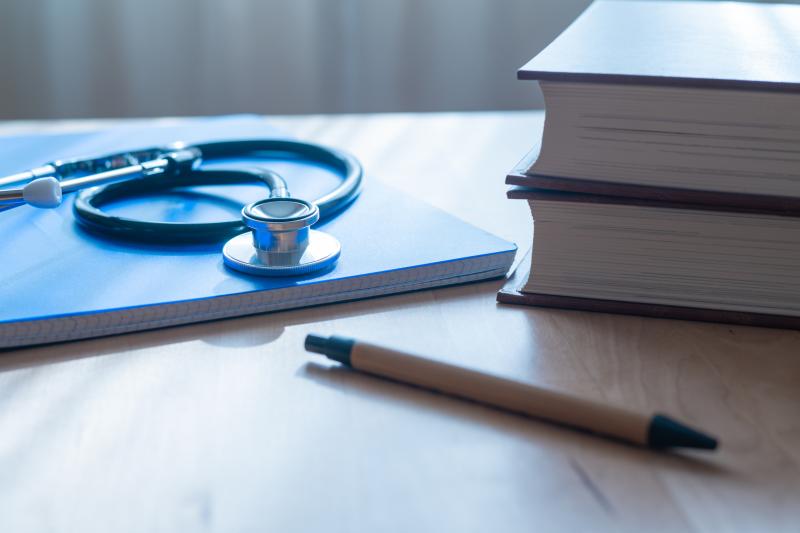 Stethoscope, pen, and books on a desk
