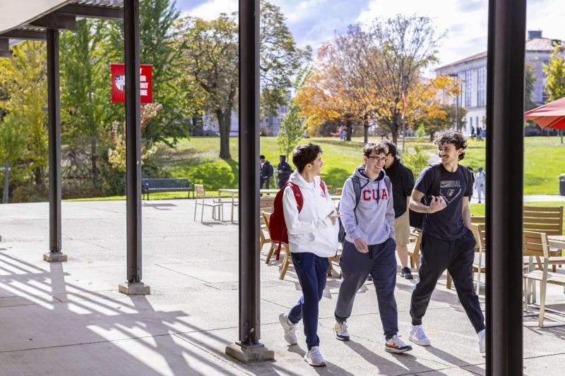 boys walking across campus chatting