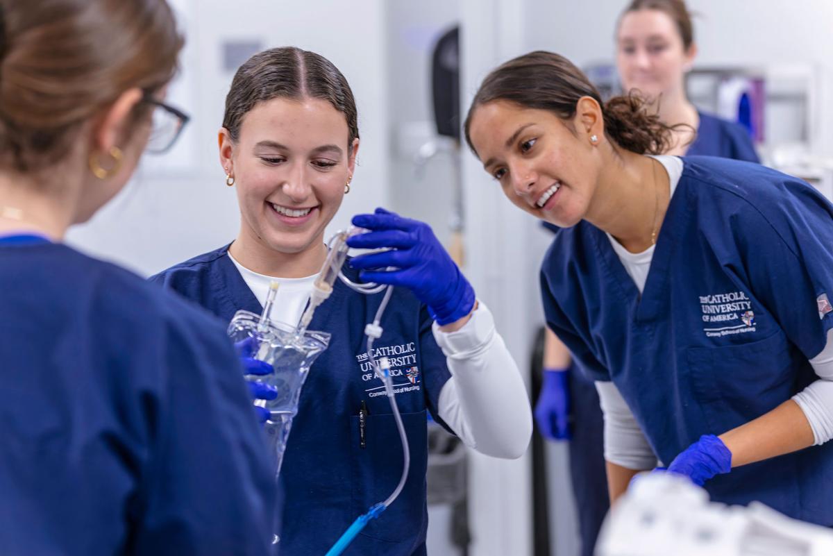Nursing students with IV bag.