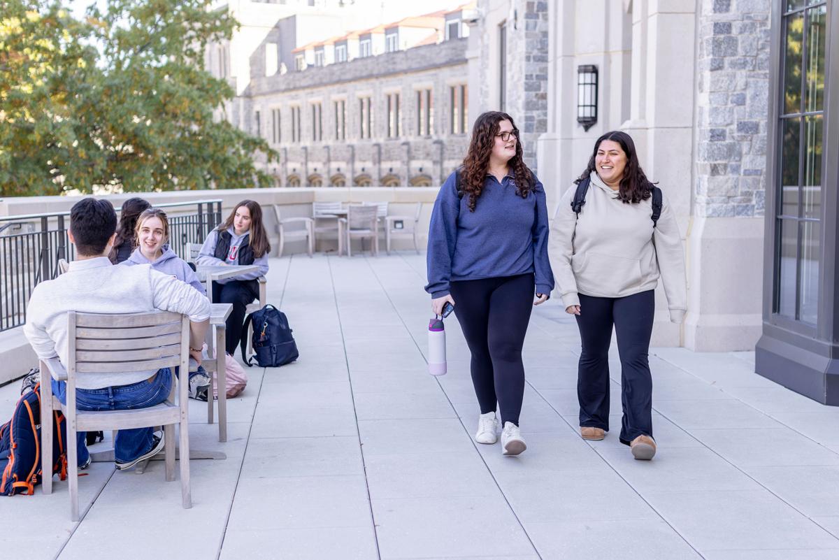 Students walking on a balcony at the Conway Building.