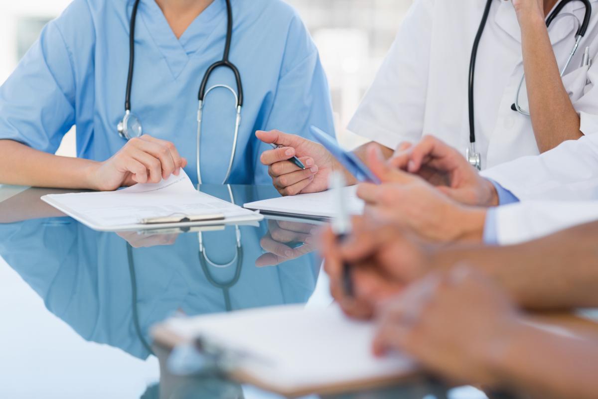 table of nurses and doctors hands