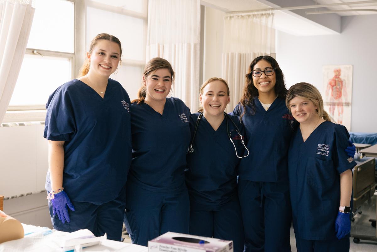 students smiling together in their scrubs