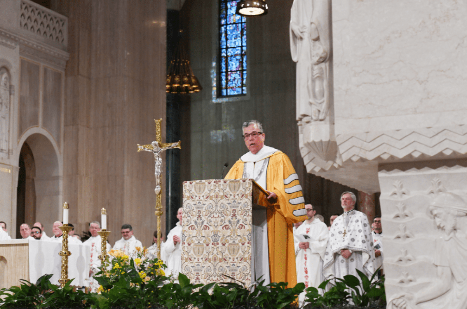 President Peter Kilpatrick speaking from the podium during Mass.