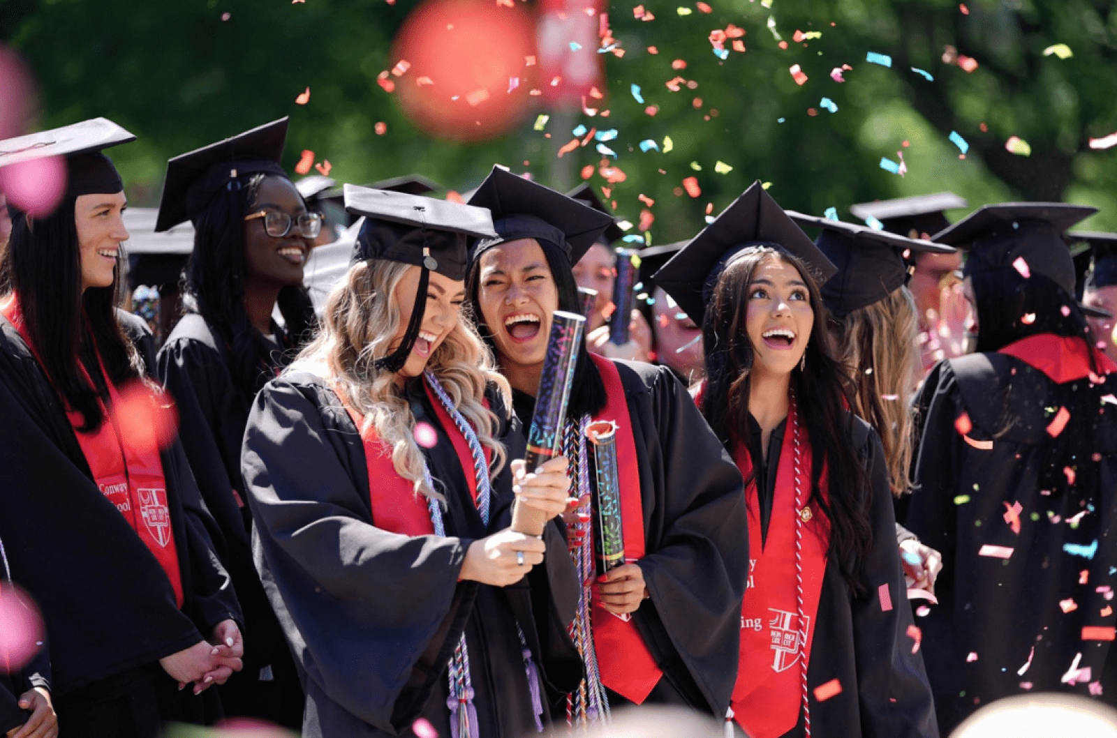 Conway School of Nursing students at Commencement, with confetti raining down on them.