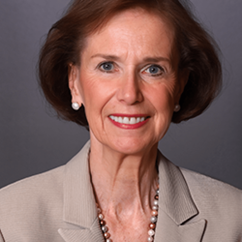 A photo of Joyce Johnson. She has a brown bob and is wearing a tan blazer.