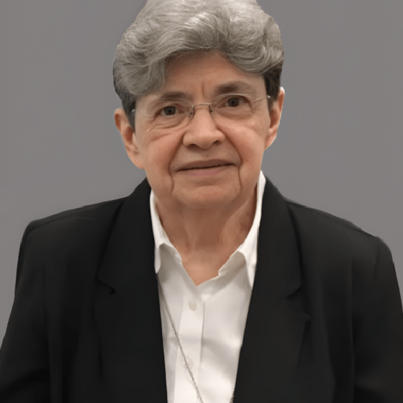 Photo of Sr. Mary Elizabeth O'Brien. She has short grey hair and is wearing a black blazer over a white shirt.