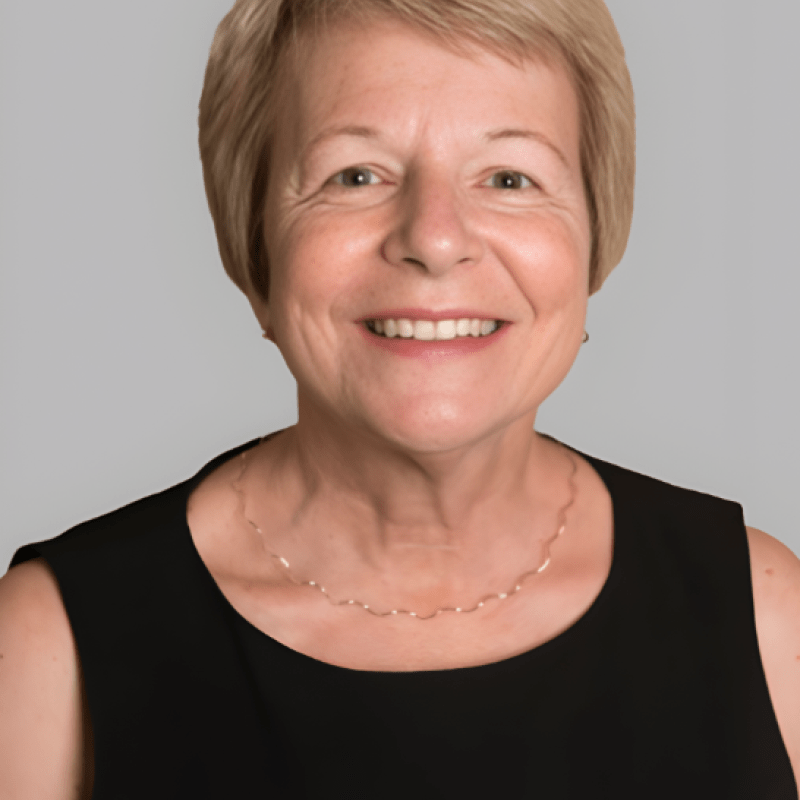 Photo of Patricia McMullen. She has short blonde hair and is wearing a black top.