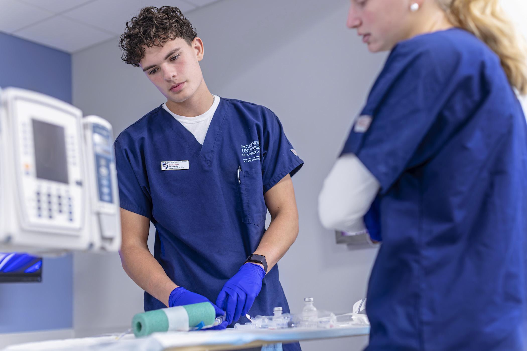 male and female nursing students in a simulation room