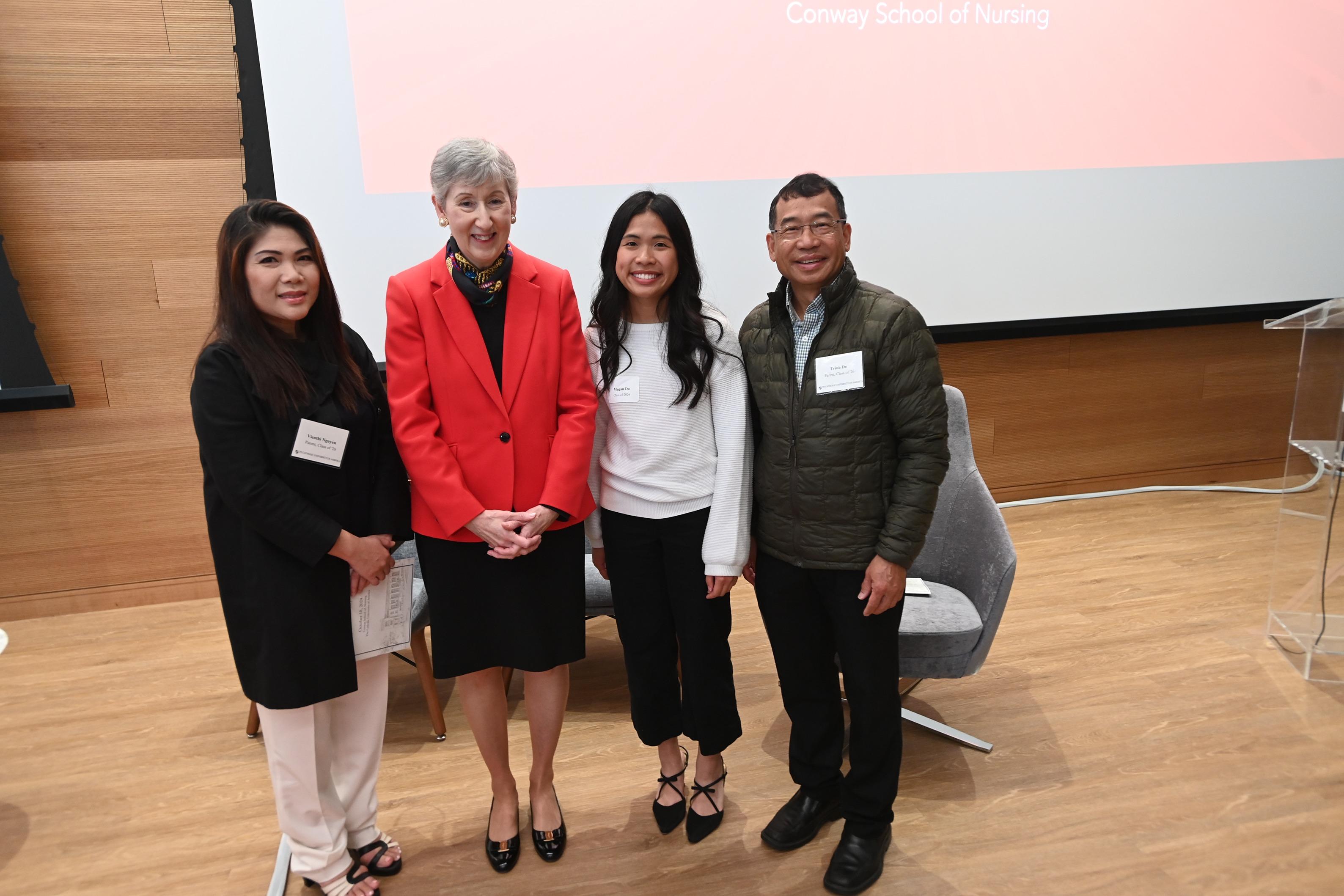 the dean of the conway school with a student and her parents