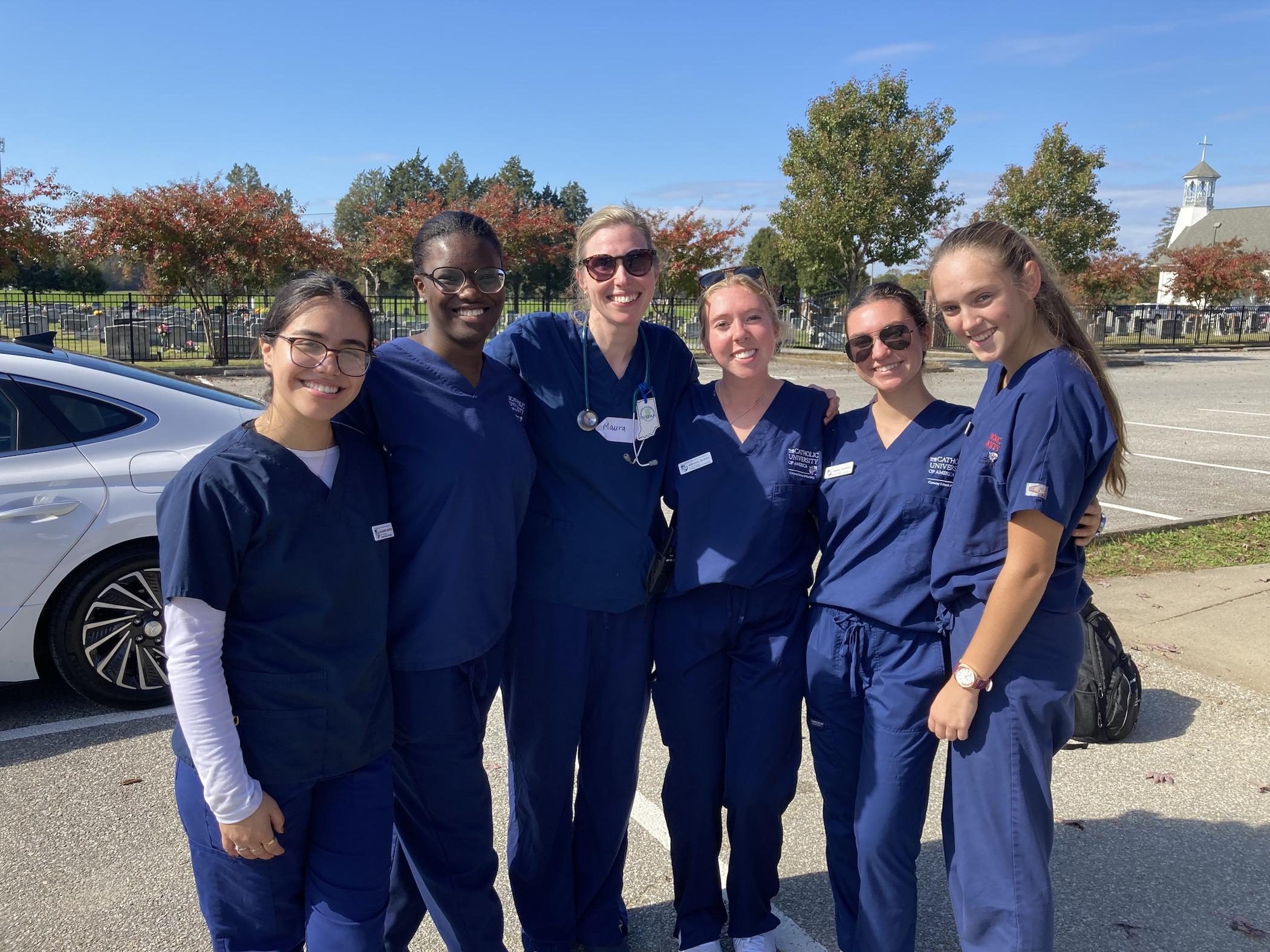 maura wenzel with her students in scrubs